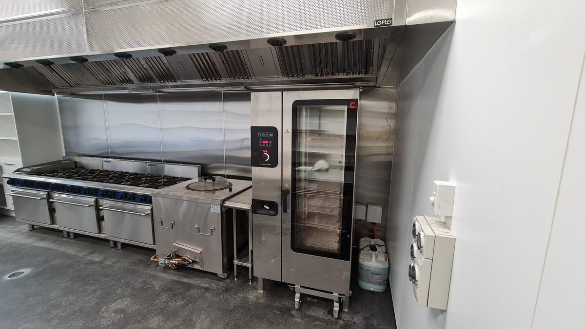 Commercial combi oven beside a cooking line