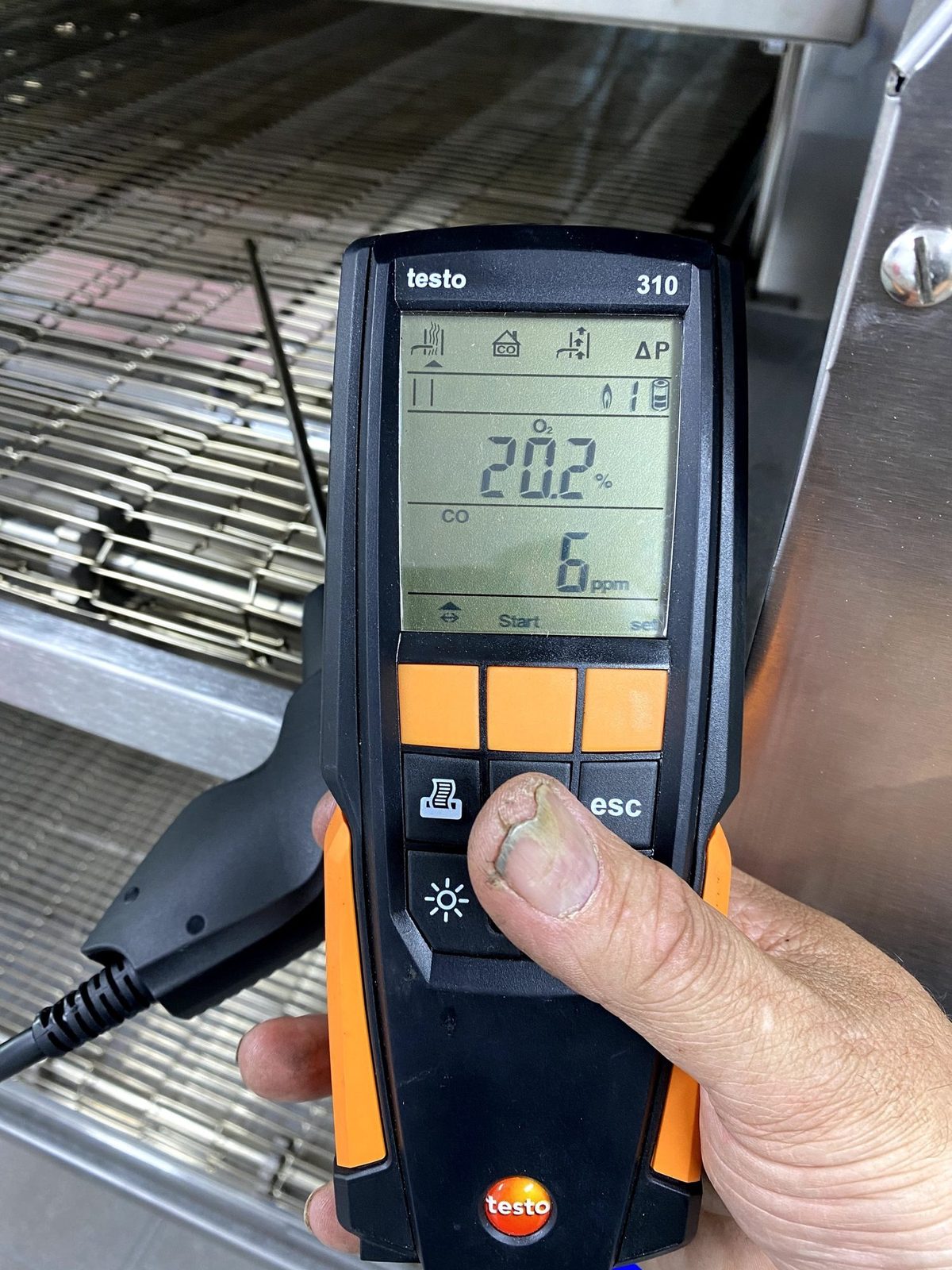 CES Wellington factory-trained technician running a Testo combustion test
