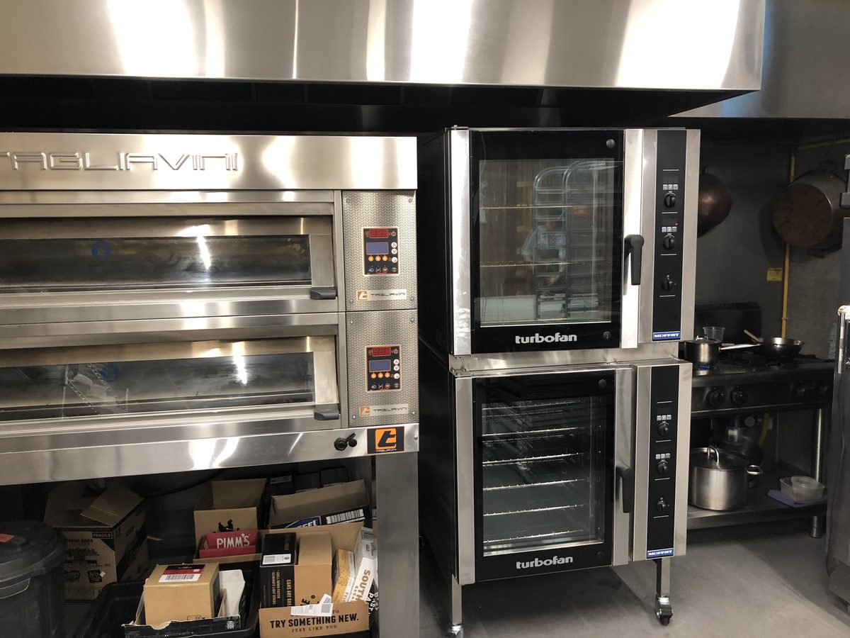 Stacked Turbofan ovens beside a deck oven